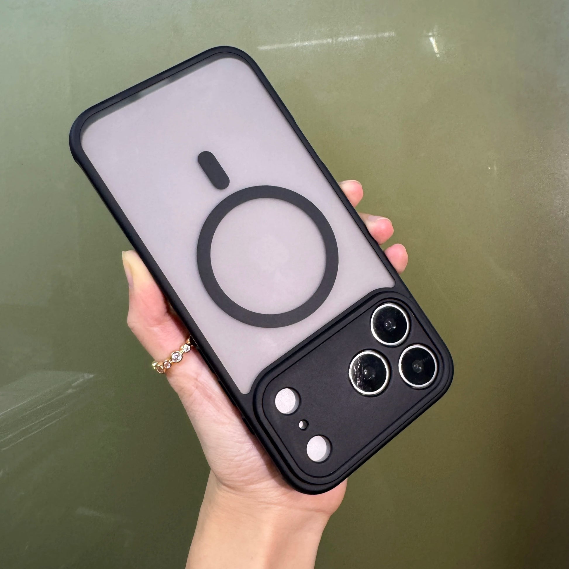 Hand holding an Iphone 17 Pro/pro max in a matte black translucent case with magsafe